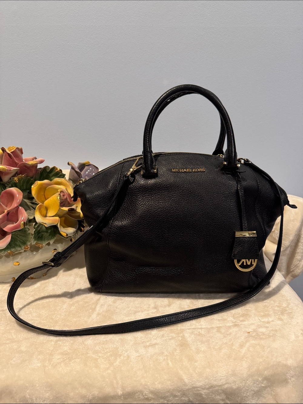 Michael Kors Riley Satchel crafted from black pebbled leather with gold hardware